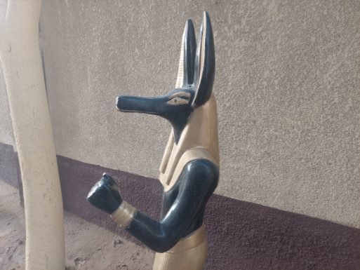 An Anibus statue with yes post
