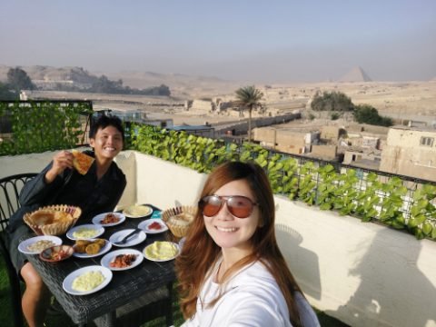 Breakfast at hostel rooftop with Pyramid view