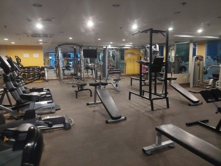 Well equipped gym with barbell and weight machine Aiyapura Hotel