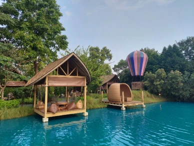 A swing boat house in bubble in the forest cafe with an airballoon nearby