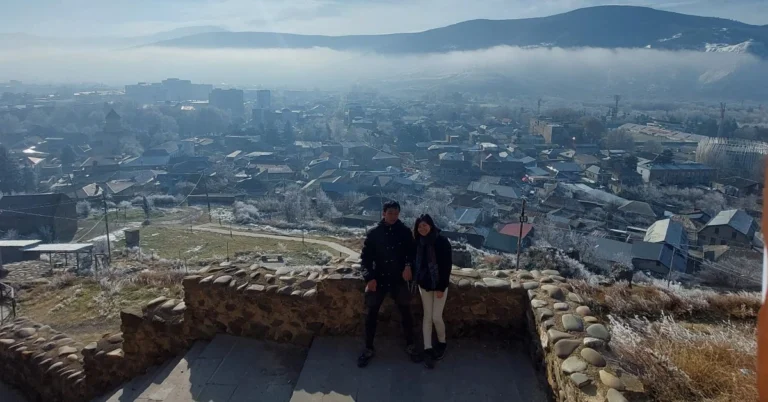 Gori-Day-Trip-Feature-Page where it shows case a couple taking a landscape photo of the whole town from Gori fortress