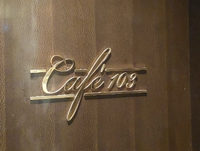Cafe 103 logo on the wall with golden word cafe 103