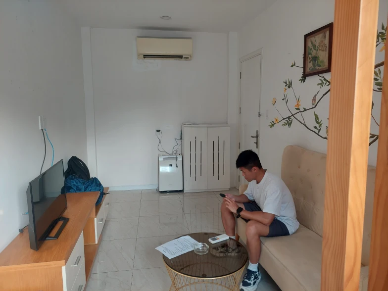 Big living room with TV for double room with my friend sitting there
