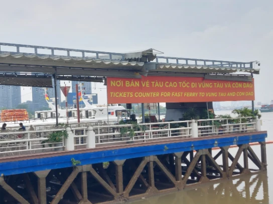 A big banner depicting ferry to Vung Tau & Can Dao at the pier