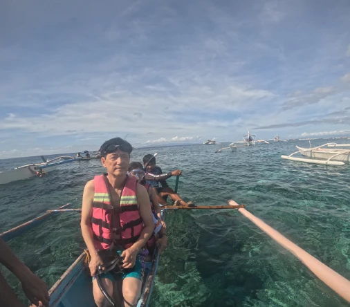 Getting on small boats for snorkeling near Balicasag Island