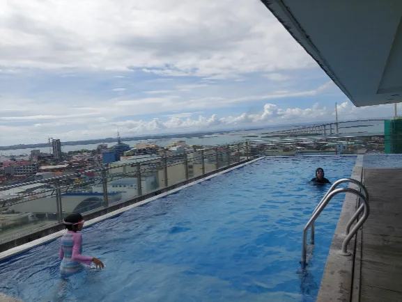 Infinity pool at One Central hotel with city view