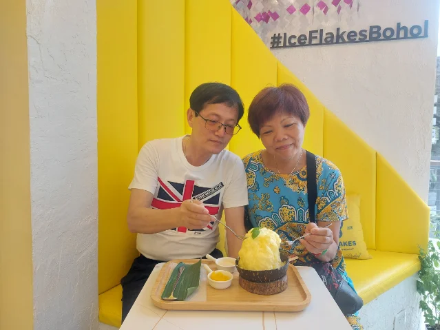 Tasting the mango ice flake near Alona beach