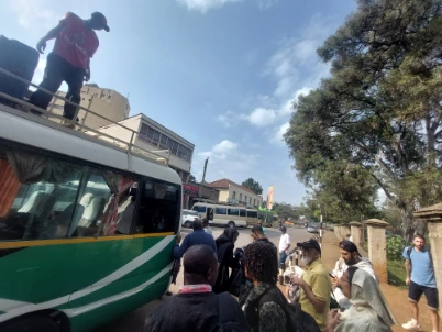 A driver on shuttle bus handling luggage