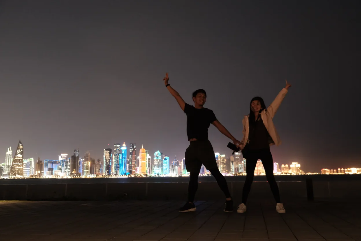 Nightview of Doha skyline with a couple