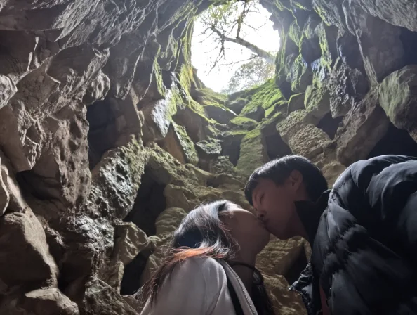 Kissing inside cave portal at Quinta da Regaleira