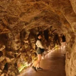 Lit stone tunnel path at Quinta da Regaleira